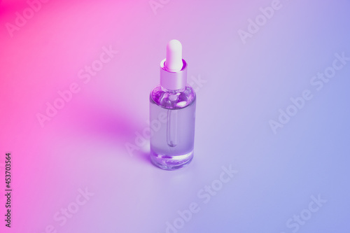 Dropper glass bottles with pipette. Transparent hyaluronic natural beauty mineral product and eco serum skin care concept. Top horizontal view copyspace. Summer juicy colors