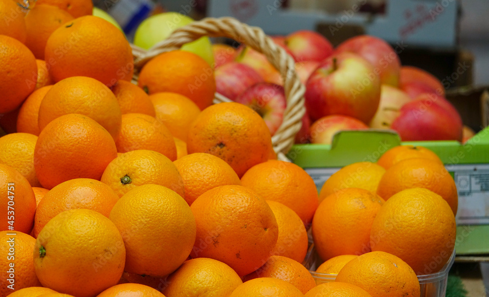 Oranges and apples for sale on a street market