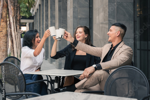 multiracial friens and colleague get together at outdoors coffee shop photo