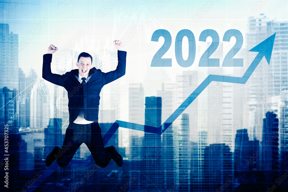 Businessman jumps with upward arrow and 2022 number Businessman jumps with upward arrow and 2022 number