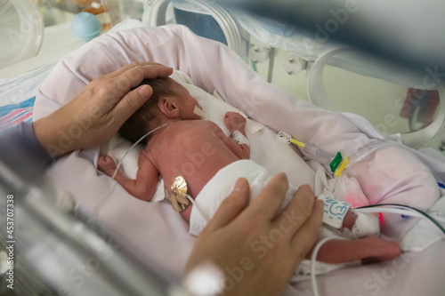 Premature newborn baby in incubator