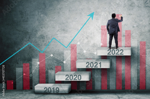 Male manager draws growth chart on 2022 numbers