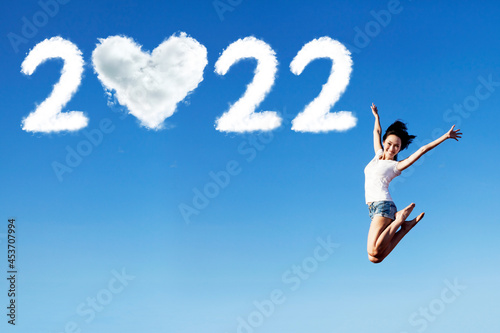 Woman jump with 2022 numbers and heart symbol