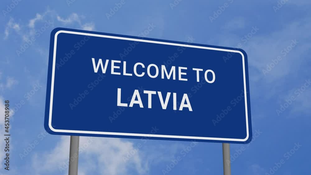 Welcome to Latvia Road Sign on Clear Blue Sky with Rapid Moving Clouds Welcome to Latvia Road Sign on Clear Blue Sky with Rapid Moving Clouds