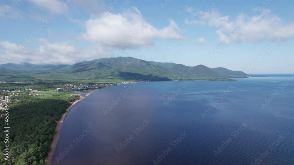 Summertime aerial imagery of Lake Baikal is a rift lake located in southern Siberia, Russia Baikal lake summer landscape view. Drone's Eye View. Summertime aerial imagery of Lake Baikal is a rift lake located in southern Siberia, Russia Baikal lake summer landscape view. Drone's Eye View.