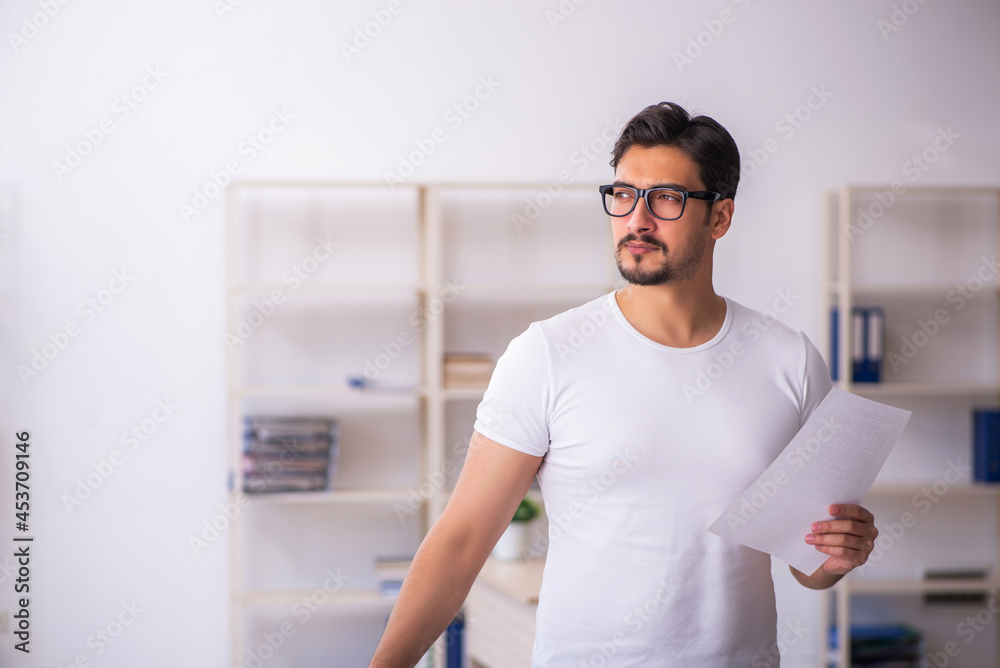 Young male student employee at workplace Young male student employee at workplace