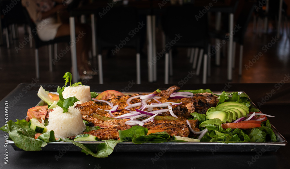 grilled fish, shaken on a salad of lettuce in a restaurante grilled fish, shaken on a salad of lettuce in a restaurante
