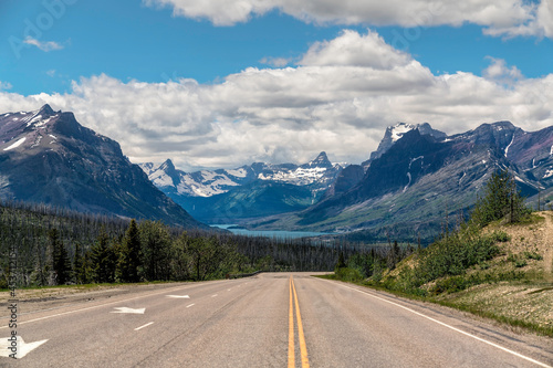 Empty asphalt road leading to Glacier National Park in Montana