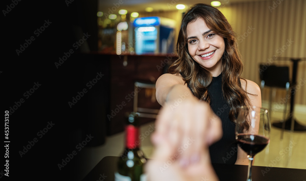 Boyfriend requesting his girlfriend's hand with an engagement ring at a restaurant Boyfriend requesting his girlfriend's hand with an engagement ring at a restaurant