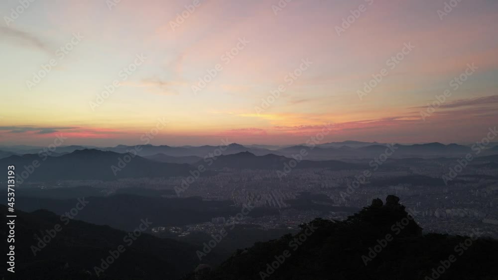Aerial shot flying over Seoul city and mountains at sunset, South Korea Aerial shot flying over Seoul city and mountains at sunset, South Korea