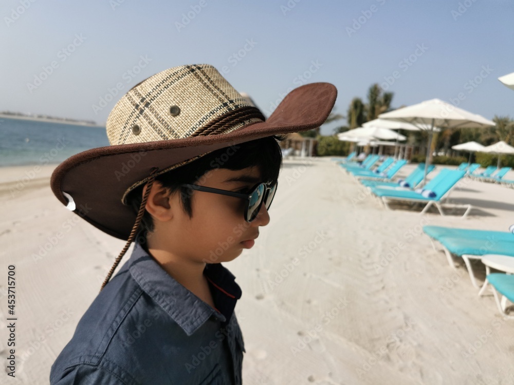 portrait of a child in a hat at beach