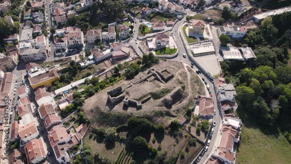 Ruins of the Castle of Alcobaça located on a hill overlooking the city, Portugal. Aerial orbiting shot Ruins of the Castle of Alcobaça located on a hill overlooking the city, Portugal. Aerial orbiting shot