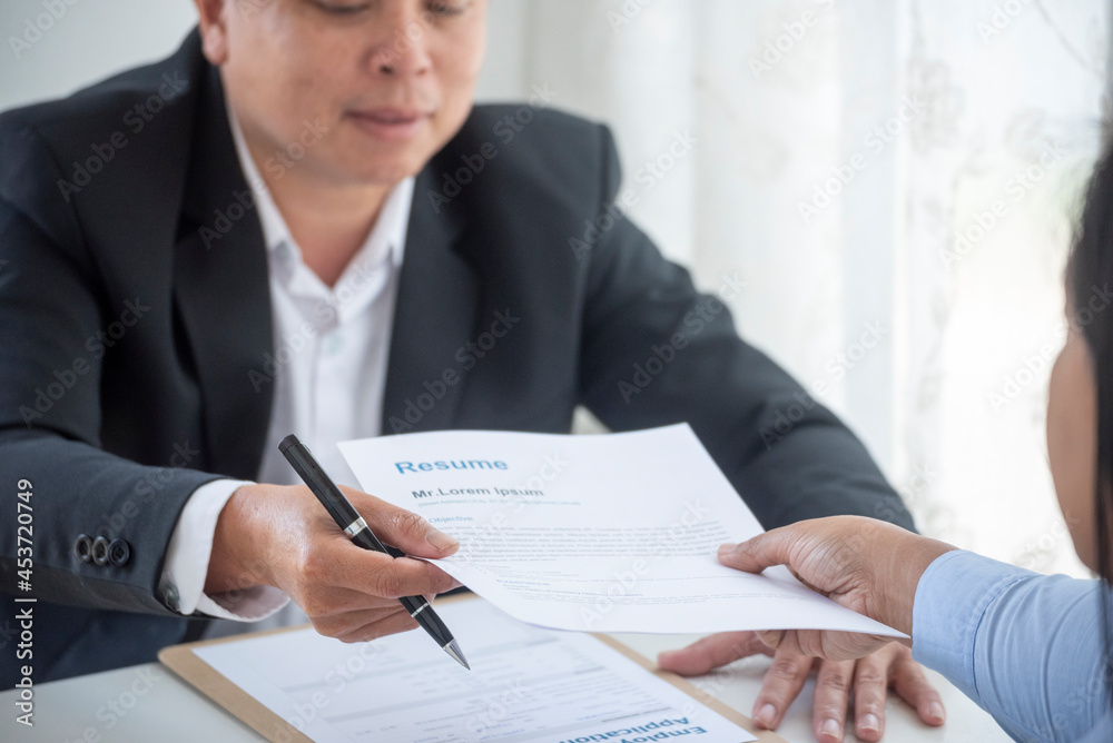 Businessman job interview by human resource HR officer interviwing, talk new employee shaking hands in office with smiling face. HR Manager interview check resume, face to face. Job Interview Concept Businessman job interview by human resource HR officer interviwing, talk new employee shaking hands in office with smiling face. HR Manager interview check resume, face to face. Job Interview Concept