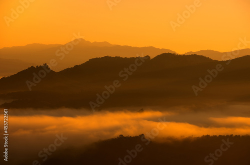 Aerial view Beautiful of morning scenery Golden light sunrise And the mist flows on high mountains and forest , Wonder fog.