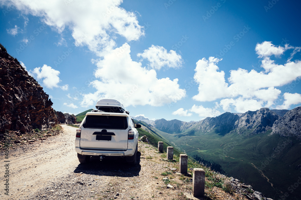 Driving off road car on high altitude mountain top