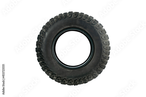All terrain tire designed for use in all road conditions isolated on white background.