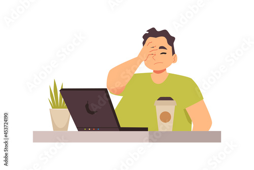Sad tired disappointed young man sit at office workplace with laptop