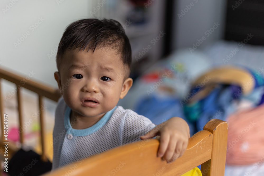 Portrait Adorable and happy 1 years old Chinese baby boy child relaxing in bed Portrait Adorable and happy 1 years old Chinese baby boy child relaxing in bed