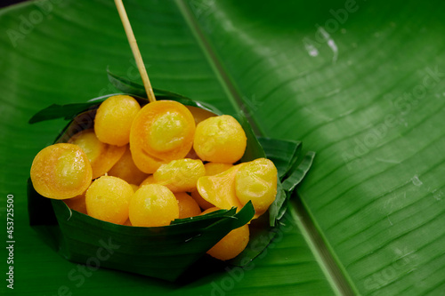 Thong Yord and Med Kanun Thai dessert in the Banana leaf bowl on green leaf banana photo