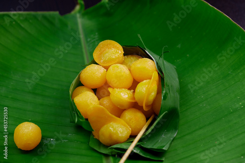 Thong Yord and Med Kanun Thai dessert in the Banana leaf bowl on green leaf banana photo