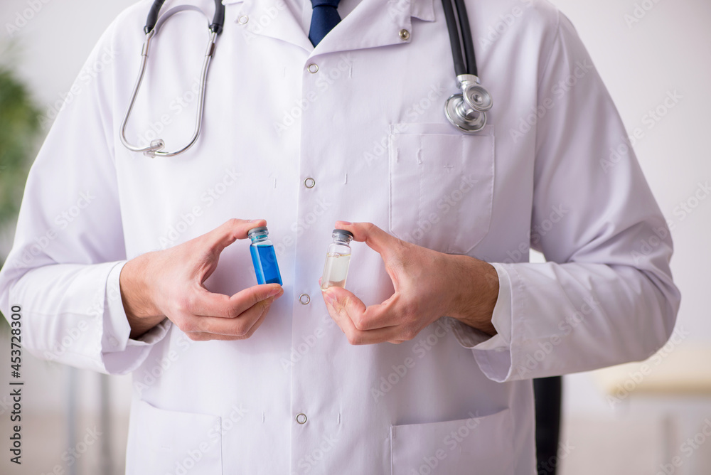 Young male doctor in vaccination concept Young male doctor in vaccination concept