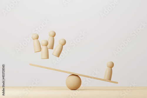 Konstfotografi Wooden human compared balancing on wood scale seesaw