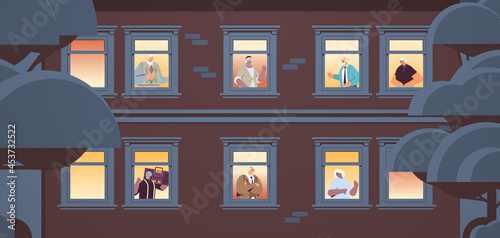 mix race senior people looking out of apartment windows old age concept house facade portrait