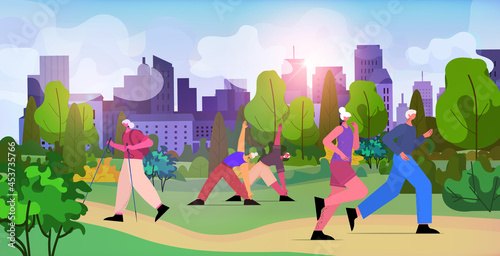 senior people group doing physical exercises in urban park aged men women training outdoor workout active old age