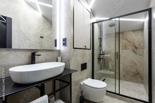 Bathroom in a traditional style with brown and gray walls.Minimalist shower room with hotel sauna