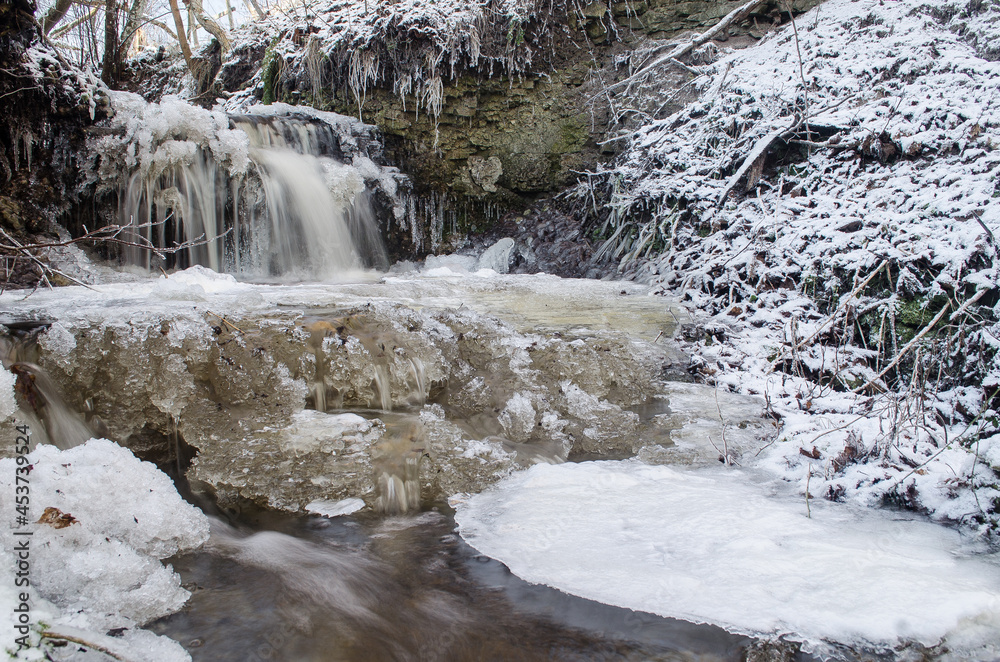 Obraz premium Zarvalks waterfall in winter day, Latvia.