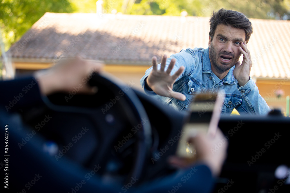 woman driving and using smartphone about to hit pedestrian - obrazy, fototapety, plakaty 