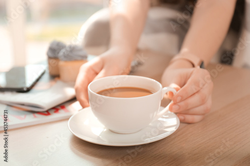 Young woman with cup of cof...