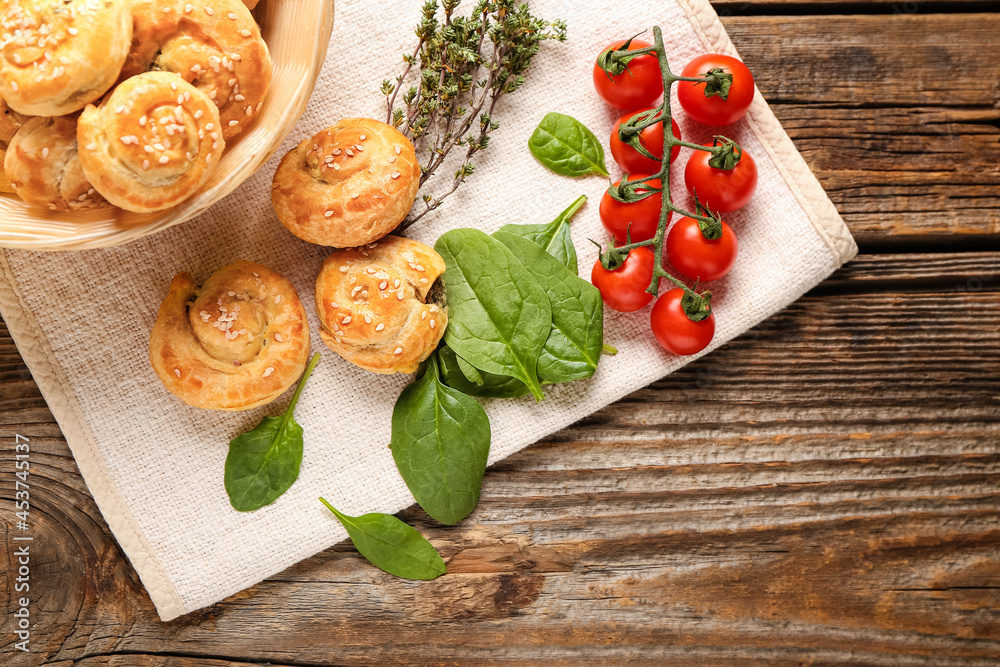 Puff pastry stuffed with spinach and vegetables on wooden background Puff pastry stuffed with spinach and vegetables on wooden background