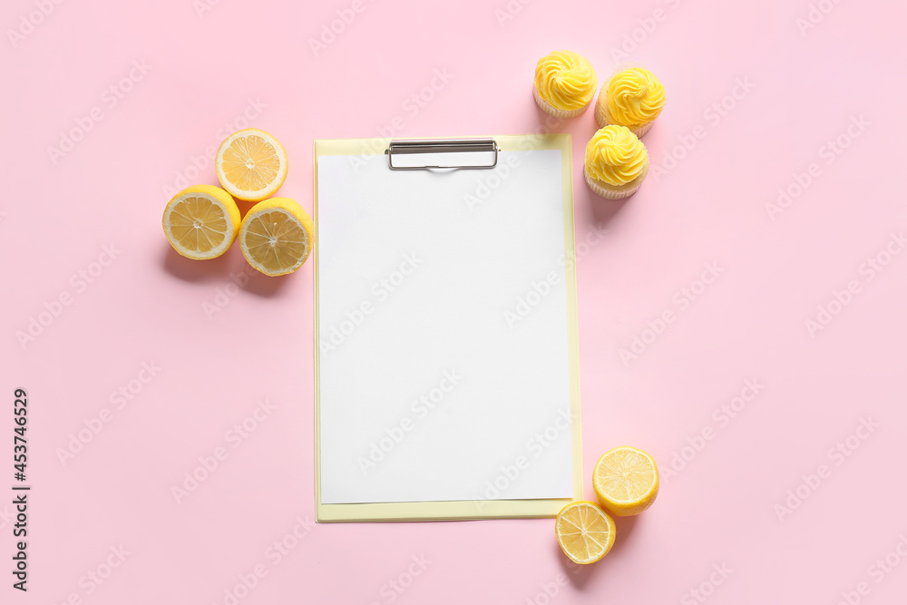 Clipboard with blank sheet of paper, lemons and cupcakes on color background Clipboard with blank sheet of paper, lemons and cupcakes on color background