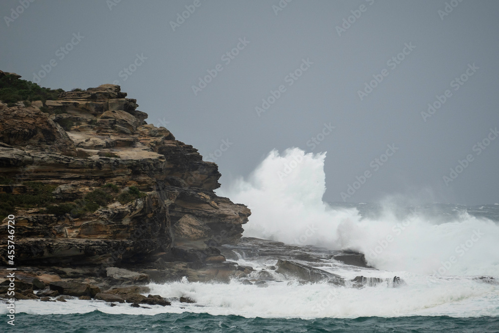 Huge waves smashing against the cliffs at Maroubra Beach/ waves crashing on rocks