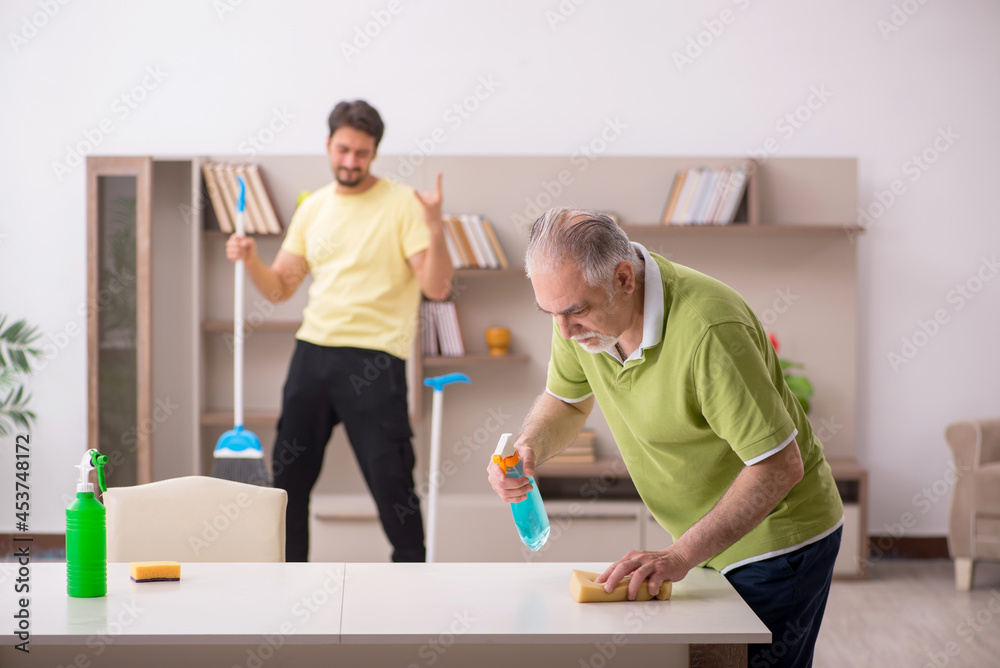 Obraz premium Two male contractors cleaning the house