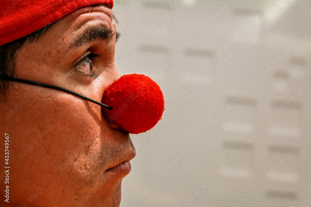 Clown look in red cap. foreground Stock-Foto | Adobe Stock