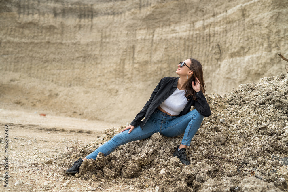 Pretty woman relax suuny summer day against sand canyon as background Pretty woman relax suuny summer day against sand canyon as background