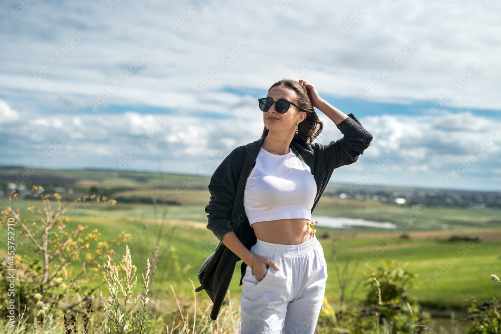 Beautiful young lady walking on the field and relax on summer vacation Beautiful young lady walking on the field and relax on summer vacation
