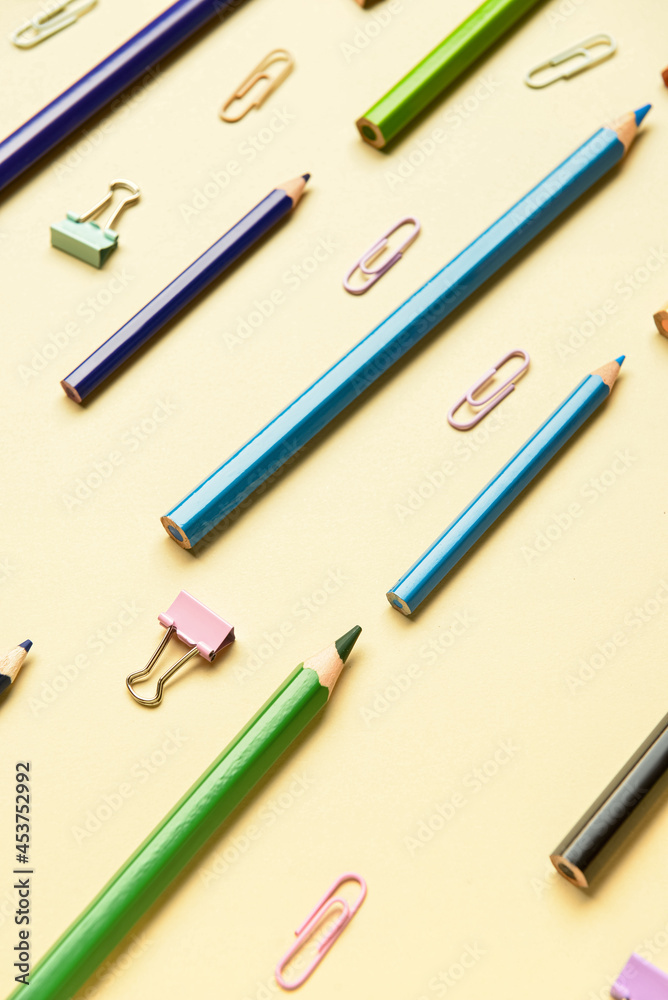 Pencils with paper clips on color background Pencils with paper clips on color background