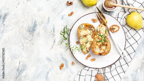 Pears baked with blue cheese, nuts and honey. French cuisine. Keto diet. Vegetarian lunch. banner, menu, recipe place for text, top view