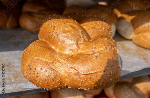 Fresh Challah with sesame seeds sold at the city farmers market photo