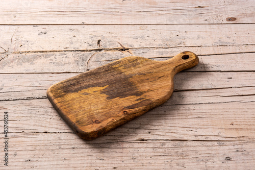 Empty wooden cutting board on wooden table photo