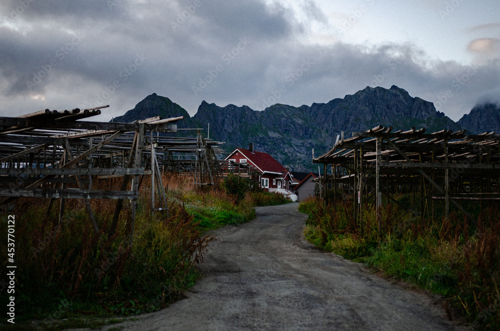 Old wooden house timber frame with mountain against a grey sky