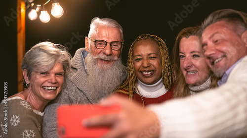 Obraz na plátne Happy multiracial senior friends having fun in holidays taking selfie with mobil