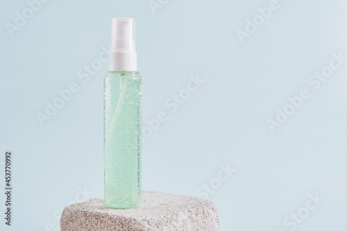 two mock up blank, plastic bottle withgreen gel on a concrete podium on a light blue background photo