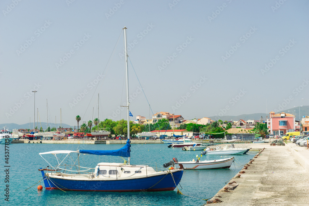 boats sway on the turquoise waves of the Ionian sea of Greece in sunny weather