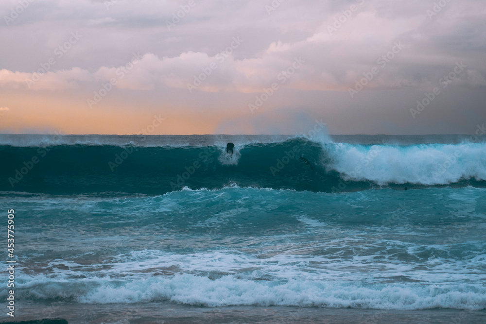 Silhoette of surfer at sunrise