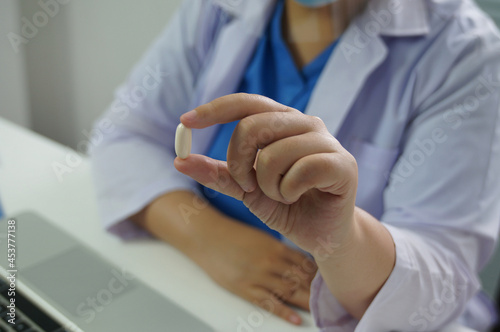 Professional medical doctor hand giving medicine. Protect against coronavirus COVID-19 medicine healthcare concept doctor giving pills to patient.