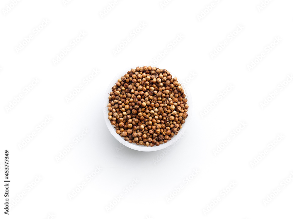 Coriander fruit isolate. A sample of coriander seeds on a white background. A sample of coriander seeds in a round bowl. Coriander fruit isolate. A sample of coriander seeds on a white background. A sample of coriander seeds in a round bowl.